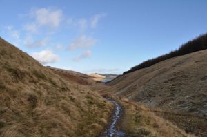 NN971014 looking NNE. At this point the highest point on the Dollar to Glendevon path has been passed and the descent begins to Glenquey; the reservoir can just be seen in the distance (2015). © Robert Struthers, Geograph