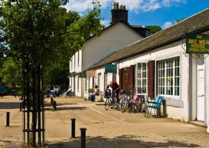 NS610795: looking west past the bike shop, craft and gift shop and Aldessan Gallery. © Ron Shephard, Geograph