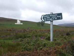 Signpost for Old military Road with Corgarff Castle in the background. © Stanley Howe, Geograph