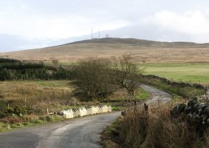 Billy Diamond's Bridge. Narrow bridge over the Englishman's Burn. Cambret Hill on the skyline with the masts. © Richard Webb, Geograph