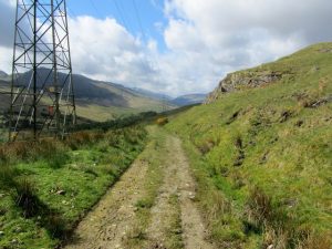 NN359231 Looking southwest along the old military road beside a line of pylons, running parallel but above the A82 (2014). © Chris Heaton, Geograph