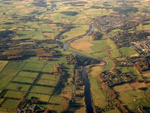 An aerial photograph taken in 2005 over the River Dee around Milltimber. The line of the former railway can clearly be seen running to the south (left) of Milltimber and Peterculter and on into the distance. © Ian K Hardie, Geograph