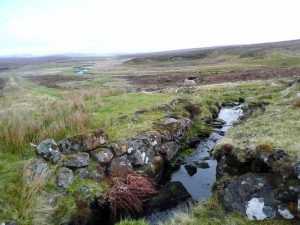 NG486594: looking south-west. Destroyed bridge on track of old mineral railway which served the diatomite extraction at Loch Cuithir. The diatomite extracted here was processed at the coast then taken to the Nobel explosives plant at Ardeer in Ayrshire. © Gordon Brown, Geograph