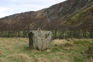 NN895306: Clach Ossian sits within the remains of a circular dyke which the Military Road passes through; the Road required the stone to be moved. Adjacent lies a grassy mound thought to be a roadbuilding soldier's grave. © Iain Macaulay, Geograph