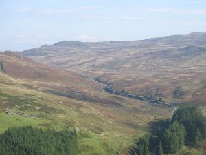 View from high on the Scurran looking north-east (2008). The A822 and Military road leave the Sma Glen; General Wade's road is left of the burn and shows as a straight line. © Richard Webb, Geograph