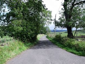 NS 772 832: looking east from Broadside along the road to Crummocksteps. This section of Roy's Road from Fintray to Falkirk and Edinbr is still in the public road network. © BJ Smur, Geograph