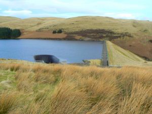 Spillway and walkway. The deep, steep-sided gulley into which the spill water from the Upper Glendevon reservoir falls, and the pedestrian walkway across the top of the dam wall. © James Allan, Geograph