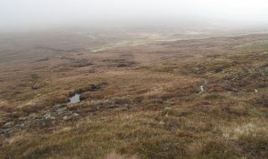 NN553400: C19 path erosion in the Lairig Breisleich. The line across the foreground is the remains of a drove route - the peat has been stripped off and boulders exposed by the hooves of many cattle. © Richard Webb, Geograph