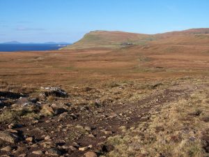 This track connects the deserted township of Lorgill to the end of the road in Ramasaig, the white house and farm buildings just visible below the distant hill. On the left, Neist Point juts out into the Little Minch, the lighthouse shows as a white dot. © Richard Dorrell, Geograph
