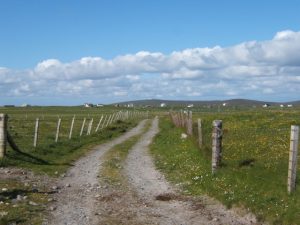 NF755364: looking NNE. West of the village of Tobha Mor (Howmore) this track leads up the coast. On the hill in the centre-distance of this picture can be seen 'Space City' on Ruabhal. © Barbara Carr, Geograph