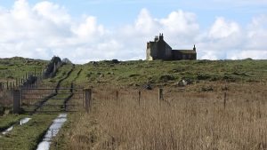 NF736338: Cnoca Breac. A rough track passes an abandoned house (2012). © Richard Webb, Geograph
