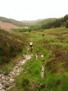 Sections of the Old Edinburgh Road are now under busy modern roads, other sections are now well-made forestry tracks, but this section has gone almost completely back to nature. This view is southwest and the loch in the distance is Black Loch NX4972. © Simon Brooke, Geograph
