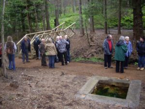 NJ 435036: the Lower Well and a rebuilt footbridge on 13th June 2009, the official opening to the public of the restored site. The wells had been all but lost beneath an invasion of rhododendron bushes until local volunteers laboured to uncover them. © Stanley Howe, Geograph