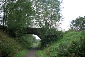NS568791: bridge carrying a track to Muirhouse crossing over the Strathkelvin Railway Path.