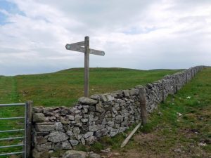 NT792190: junction of bridleways near Hownam Rings (2009). The Street's track on the other side of the wall (as shown on the map) is at least initially not so clear on the ground. A left turn through the gate takes you NE to Belford in the Bowmont valley. © Andrew Curtis, Geograph