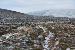 NT181339 looking SSW (2014). Here the Thief Road is visible contouring away to the right around the summit of Breach Law. Nowadays it forms part of the route of the Manor Water Hill Race from Kirkton to the summit of The Scrape (on the skyline) and back. © Jim Barton, Geograph