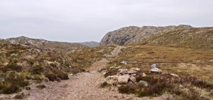 NG864762 looking NNW. The route is a fine one and the path gives easy walking. The view is from the highest point on the crossing looking towards Poolewe with Creag Mhor Thollaidh the peak in view. © Trevor Littlewood, Geograph