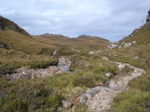 NG859785 Allt a' Pholl-choire by the Tollie path. Taken looking North, with the Poolewe-Gairloch road visible in the background. © Roger McLachlan, Geograph