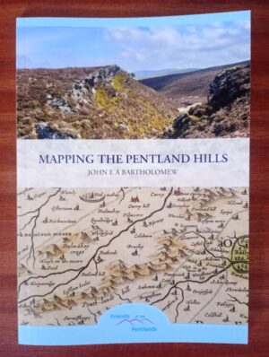A small booklet sat on a wooden table. The name of the book is in the middle and reads "Mapping The Pentland Hills - John E A Bartholomew". The top of the book is a picture of the Pentland Hills and the bottom is an old map extract showing the Pentland Hills. At the bottom of the page is the logo of the Friends of the Pentlands.